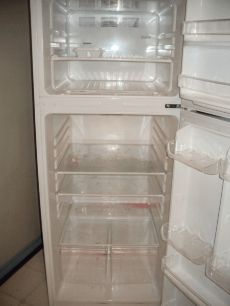 An empty, broken refrigerator