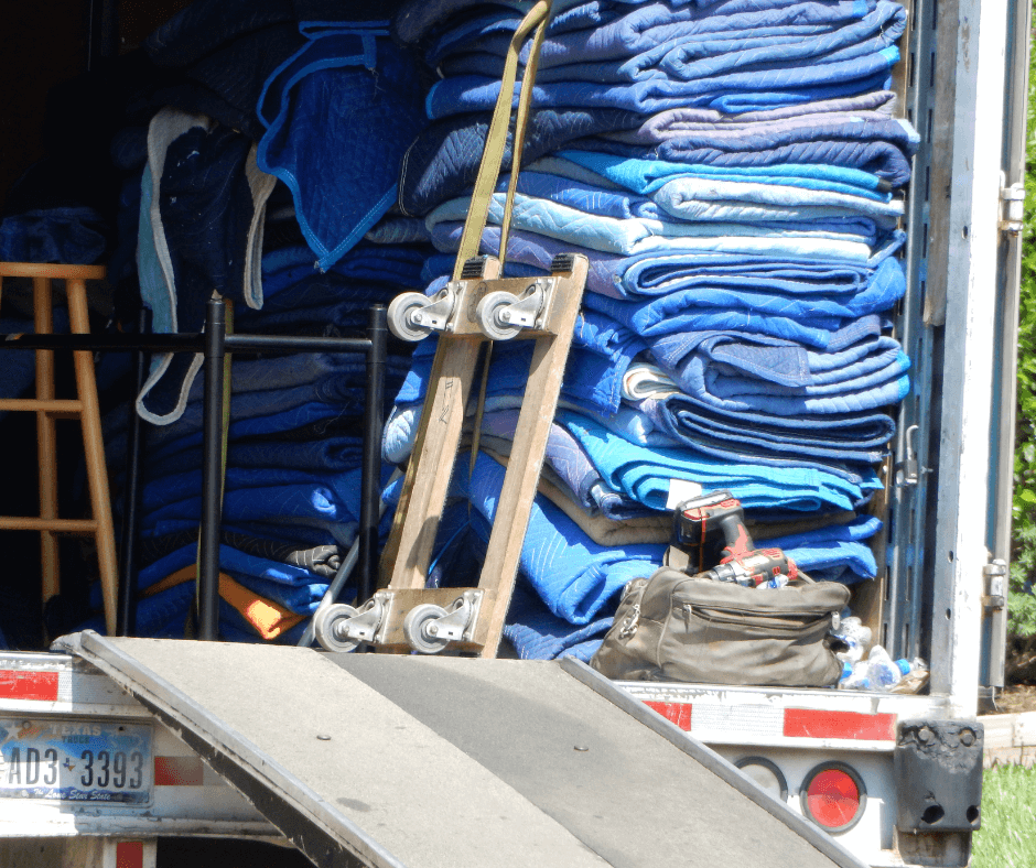 Heavy-duty moving blankets prepared in a delivery truck for the safe transport of refrigerators and washers.